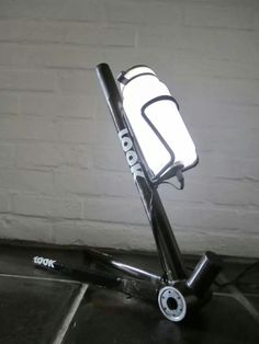 a light that is on top of a scooter in front of a wall