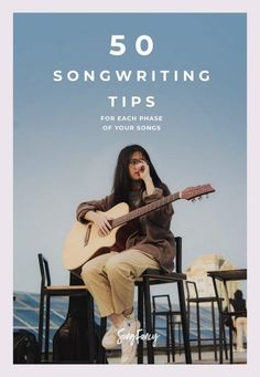 a woman sitting on top of a chair holding a guitar