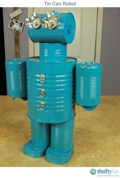 a blue tin can robot sitting on top of a counter