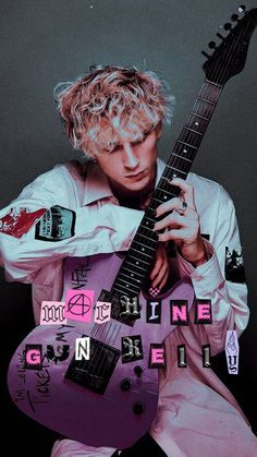 a man with blonde hair is holding a purple guitar and posing for the camera in front of a black background