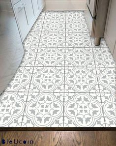 a kitchen floor with white and gray tile