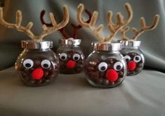 three glass jars with reindeer noses and antlers in them