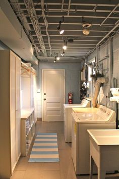 an empty laundry room with washers and dryer