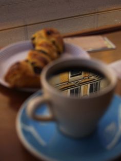 a cup of coffee and some pastries on a table