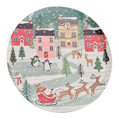 a paper plate decorated with christmas scenes and reindeers on the snow covered ground in front of houses