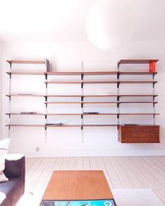 a living room filled with furniture and shelves