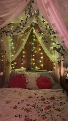 a bed covered in white curtains and lights