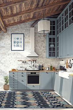 a kitchen with gray cabinets and an area rug