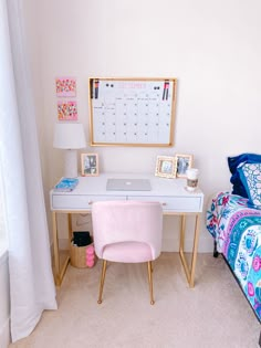 a desk with a laptop on it next to a pink chair and bed in a room