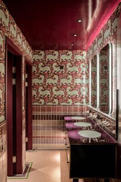 a bathroom with two sinks and mirrors in it