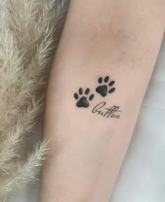 a woman's arm with a paw print on it and the word cat mom written in cursive font