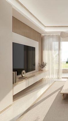 a living room with white furniture and a flat screen tv mounted on the side of a wall