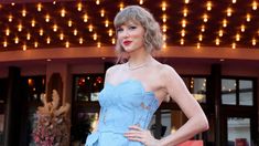 a woman in a blue dress posing for the camera