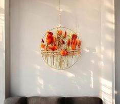 a living room filled with furniture and a round mirror hanging on the wall above it