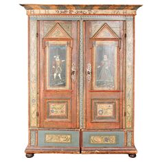 an old wooden cabinet with paintings on it