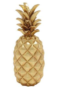 a gold pineapple shaped vase sitting on top of a table