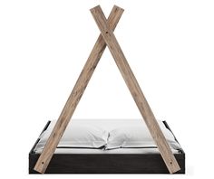 a bed with two wooden poles sticking out of it's sides and pillows on the bottom