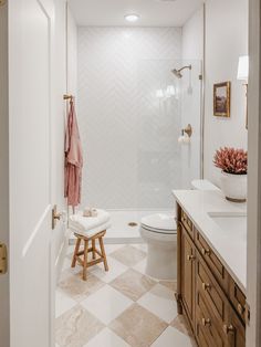 a bathroom with a toilet, sink and shower in it's center piece is shown