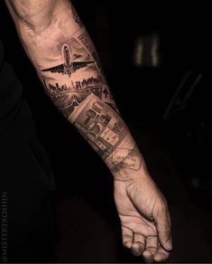 a man's arm with an airplane and money tattoo on the left hand,