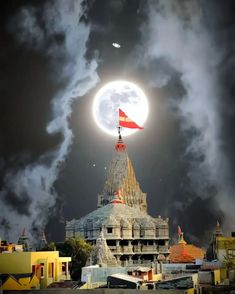 a full moon is seen over a temple in the sky with clouds and buildings around it