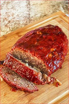 sliced meatloaf on a cutting board with ketchup