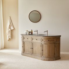 a bathroom with a sink, mirror and towel rack on the wall next to it