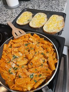 a pan filled with pasta and bread on top of a stove