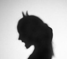 the silhouette of a woman's head is shown in black and white, with long hair