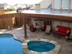 a backyard with a hot tub and patio furniture