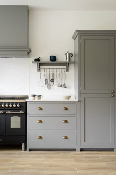 a kitchen with gray cabinets and white walls