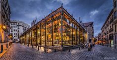 a glass building sitting in the middle of a street