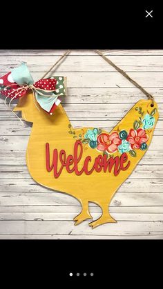 a wooden sign that says welcome with a chicken on it's head and bow tie around its neck