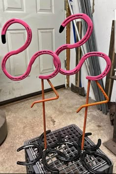 two pink flamingos standing on top of each other