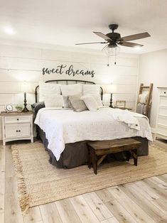 a bedroom with a bed, dresser and ceiling fan in it's center area