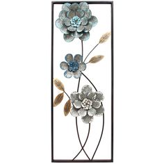 a metal wall hanging with flowers and leaves on it's side, against a white background