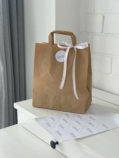 a brown paper bag sitting on top of a white table