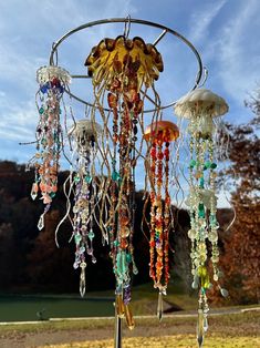 a wind chime with jellyfishs and other beads hanging from it's sides