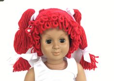 a doll with red hair wearing a white dress