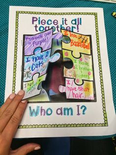 a person holding up a piece of paper with the words who am i?