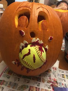 a pumpkin with a baseball in it's mouth