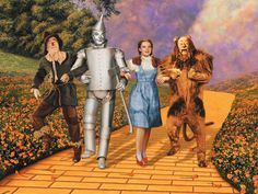 the wizard of oz poster with three children and an adult in costume walking down a path