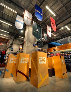 the inside of a sports store with banners hanging from the ceiling