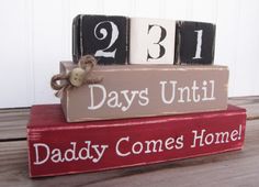 two blocks that say, days until daddy comes home and the number thirteen sits on top of each block