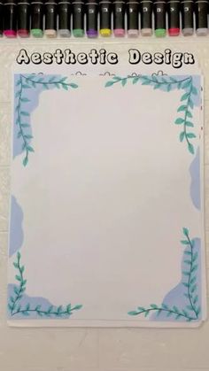 a sheet of paper with an artistic design on it and markers in front of it