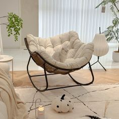 a white chair sitting on top of a rug in a living room