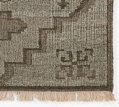 a brown and white rug with fringes on it