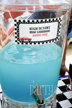 a blue drink sitting on top of a black and white checkered table