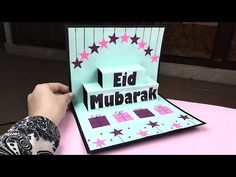 someone is cutting out the word eid mubarak on a card