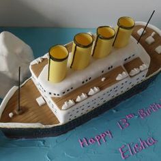 a cake shaped like a ship with candles on it