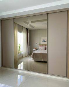 an image of a bedroom with mirrored closet doors